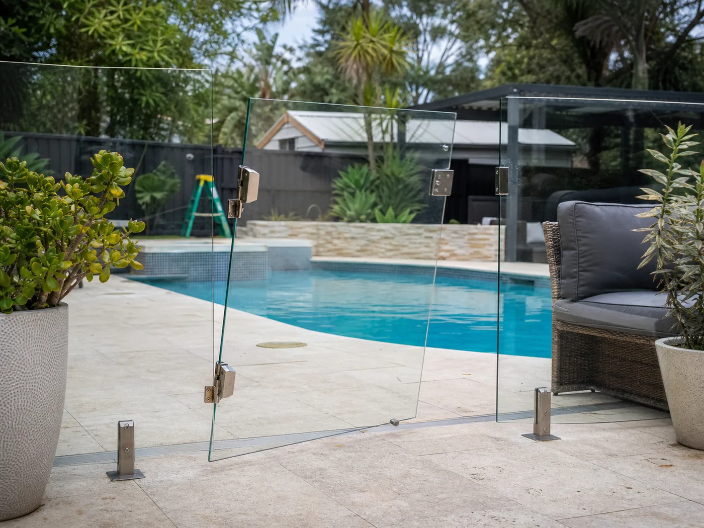 Illustration of a glass pool fence gate left ajar with potential safety issues